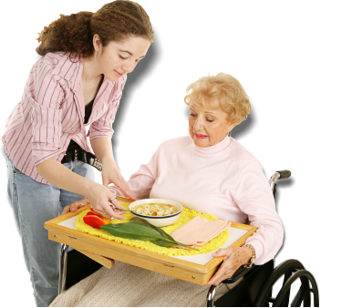 caregiver assisting patient in eating her food