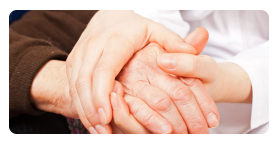 caregiver holding the hands of the patient